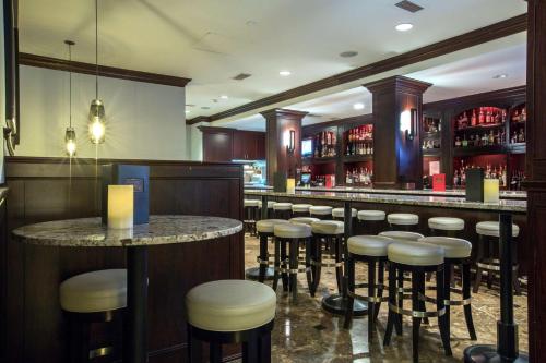 a bar with stools and a counter in a restaurant at Hilton Columbia Center in Columbia