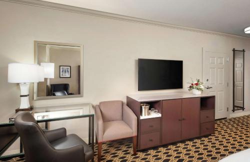 a hotel room with a television and a desk and chair at Hilton Columbia Center in Columbia
