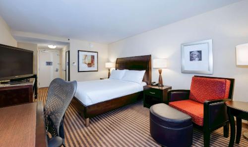 a hotel room with a bed and a chair at Hilton Garden Inn Columbia/Northeast in Columbia