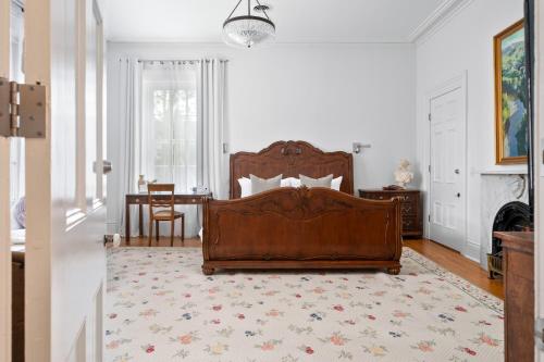 a bedroom with a bed and a rug at The CAPE in Picton