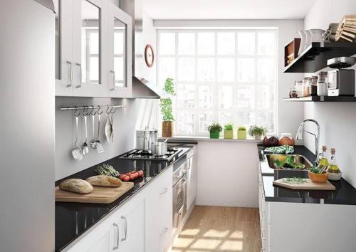 a kitchen with white cabinets and vegetables on a counter at Tu descanso in Mexico City