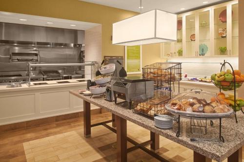a kitchen with a counter with food on it at Hilton Garden Inn Akron in Akron