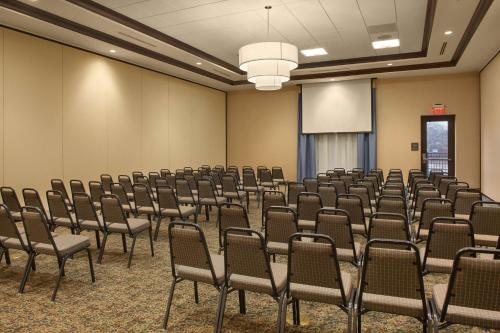 an empty room with chairs and a screen at Hilton Garden Inn Akron in Akron