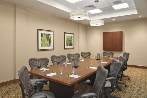 a conference room with a large wooden table and chairs at Hilton Garden Inn Akron in Akron