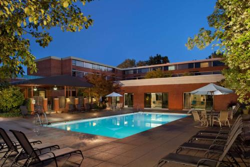 a swimming pool in front of a building at Hilton Akron Fairlawn in Fairlawn