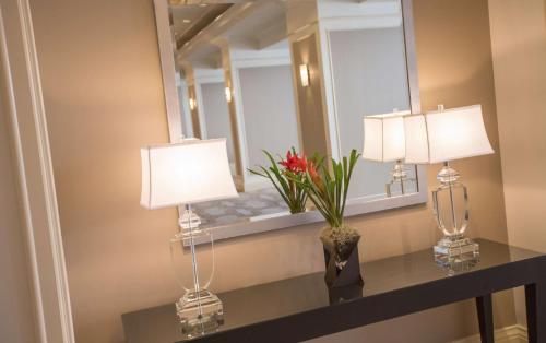 two lamps on a table in front of a mirror at DoubleTree by Hilton Chicago - Oak Brook in Oak Brook