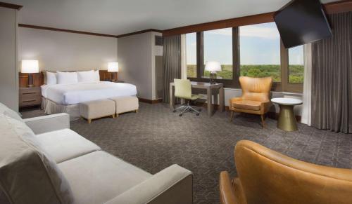 a hotel room with a bed and a desk at DoubleTree by Hilton Chicago - Oak Brook in Oak Brook