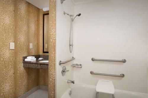 a bathroom with a toilet and a sink at Hilton Garden Inn Charlotte/Mooresville in Mooresville