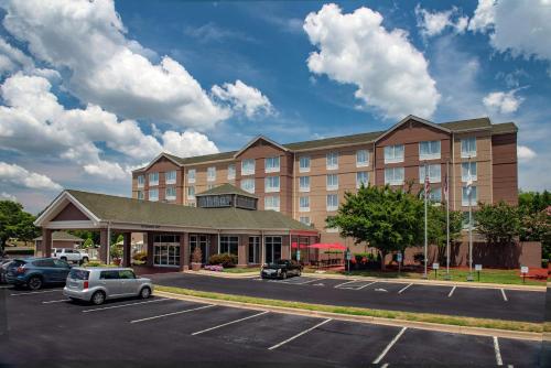 a hotel with a car parked in a parking lot at Hilton Garden Inn Charlotte Pineville in Charlotte