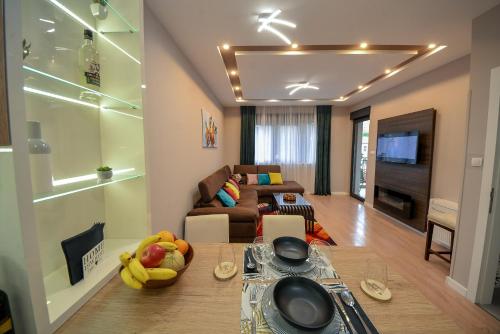 a living room with a couch and a table with fruit on it at Pine 1 apartment in the center in Trebinje