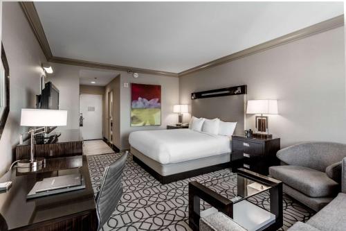a hotel room with a bed and a living room at Hilton Columbus at Easton in Columbus