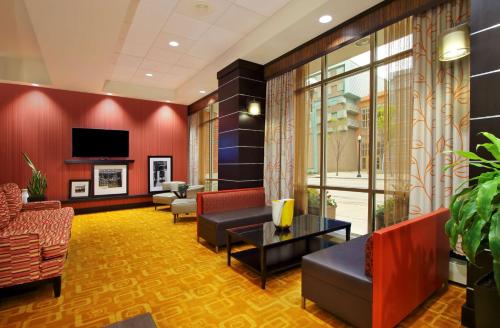 a waiting room with couches and a tv in a building at Hampton Inn & Suites Columbus-Downtown, Ohio in Columbus