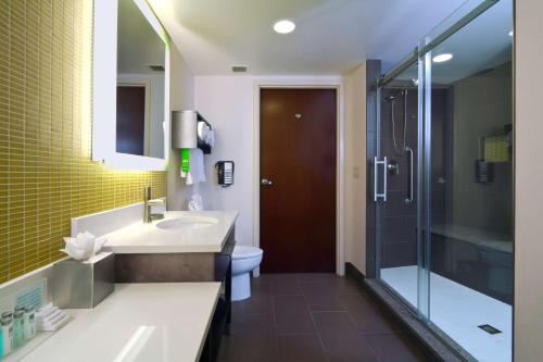 a bathroom with a sink and a shower and a toilet at Hampton Inn & Suites Columbus-Downtown, Ohio in Columbus