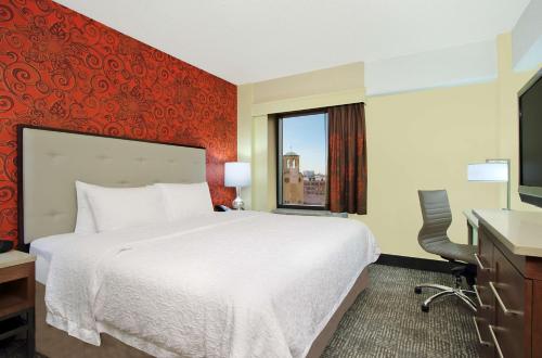 a hotel room with a large bed and a window at Hampton Inn & Suites Columbus-Downtown, Ohio in Columbus