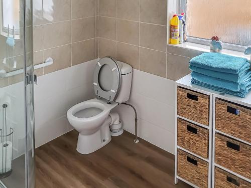 a bathroom with a toilet and a glass shower at Little London in Bognor Regis