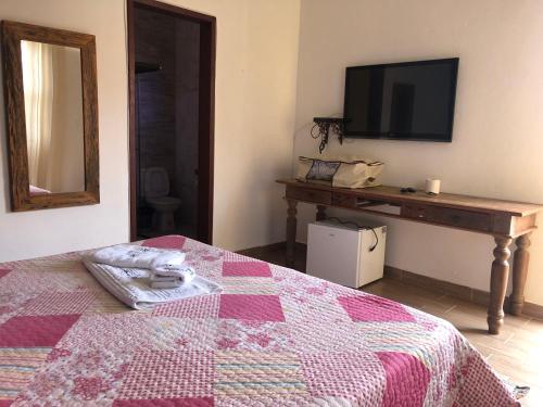 Ένα ή περισσότερα κρεβάτια σε δωμάτιο στο Pousada Vó Iris - Tiradentes Mg
