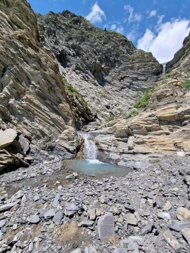 a small pool of water in a rocky mountain canyon at Lahij Rashad Ismayilov Hotel in Lahıc