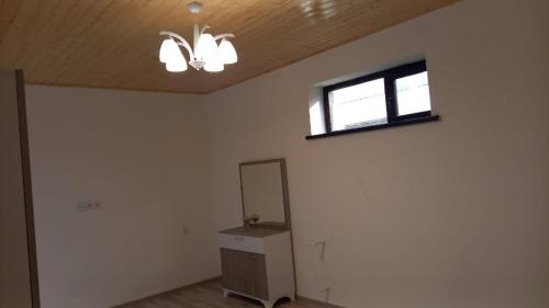 an empty room with a mirror and a window at Lahij Rashad Ismayilov Hotel in Lahıc