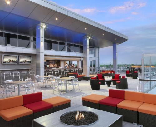 a rooftop patio with tables and chairs and a fire pit at The Broadway Columbia - a DoubleTree by Hilton Hotel in Columbia