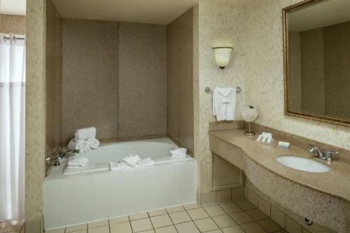 a bathroom with a tub and a sink at Hilton Garden Inn Corvallis in Corvallis