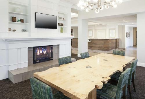a dining room with a table and a fireplace at Hilton Garden Inn Dallas/Allen in Allen