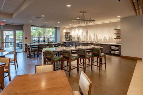 a restaurant with tables and chairs and a bar at DoubleTree by Hilton Dallas-Farmers Branch in Farmers Branch