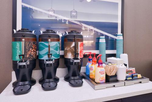 a group of coffee machines on a shelf in a room at Homewood Suites by Hilton Dallas-Lewisville in Lewisville