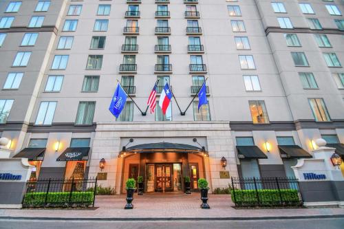 a hotel with flags on the front of it at Hilton Dallas-Park Cities in Dallas
