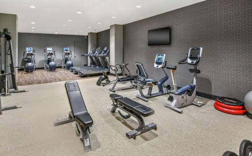 a gym with a bunch of exercise equipment in a room at Hilton Dallas-Park Cities in Dallas
