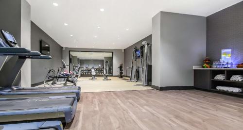 a gym with treadmills and exercise equipment in a room at Hilton Dallas-Park Cities in Dallas