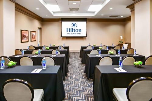 a room with rows of tables and chairs in it at Hilton Dallas-Park Cities in Dallas