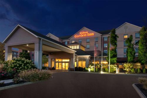 a hotel exterior at night with a building at Hilton Garden Inn Dayton/ Beavercreek in Beavercreek