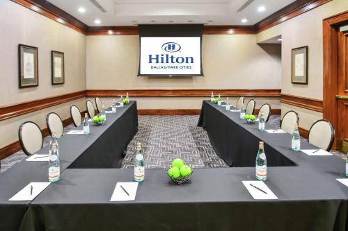 a row of tables in a room with wine bottles at Hilton Dallas-Park Cities in Dallas