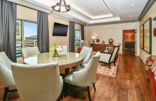 a dining room with a table and chairs at Hilton Dallas-Park Cities in Dallas
