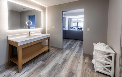 a bathroom with a sink and a mirror at Hilton Dallas/Rockwall Lakefront Hotel in Rockwall