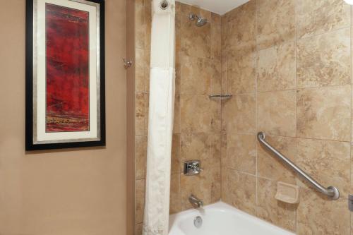 a bathroom with a shower with a tub at DoubleTree Suites by Hilton Dayton/Miamisburg in Miamisburg