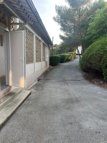 an empty driveway next to a building with a gate at Zara at Saint Raphael France in Saint-Raphaël