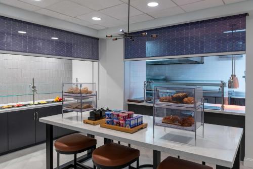a kitchen with a table with some food on it at Hilton Garden Inn Arlington/Courthouse Plaza in Arlington