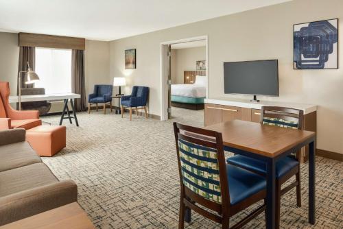 a living room with a couch and a table in a hotel room at Hilton Garden Inn Dubuque Downtown in Dubuque