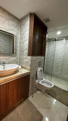 a bathroom with a toilet and a sink and a shower at Appartement Anir in Agadir