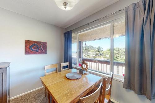 a dining room with a table and a large window at Coastal Vista in Neskowin