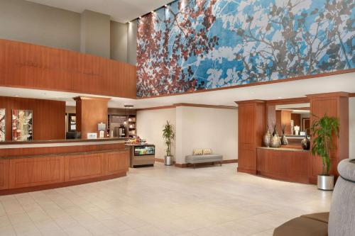 a lobby with a large painting on the wall at Hilton Garden Inn Tysons Corner in Tysons Corner