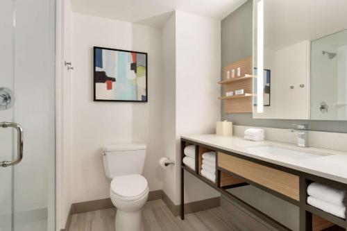 a bathroom with a toilet and a sink at Hilton Garden Inn Tysons Corner in Tysons Corner