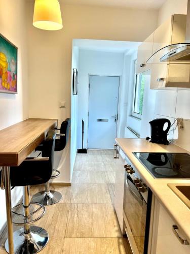 a kitchen with a counter and a table with chairs at Familly Apartament 4 in Międzyzdroje
