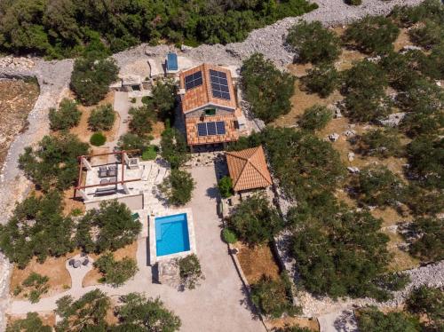 an aerial view of a house with a swimming pool at Trapula stone paradise in Maslinica