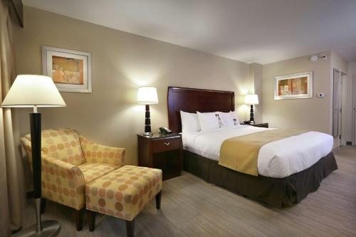a hotel room with a bed and a chair at DoubleTree by Hilton Hotel Denver - Thornton in Thornton