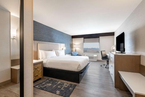 a hotel room with a bed and a desk at DoubleTree by Hilton Hotel Denver - Thornton in Thornton