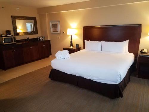 a large bed in a hotel room with a white bedspread at DoubleTree by Hilton Hotel Denver - Thornton in Thornton