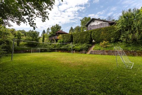 a soccer field with a net in a yard at Private summer house with swimming pool, beach bar and pit for football and volleyball in Hvězdonice
