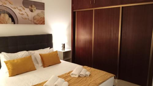 a bedroom with a bed with two towels on it at Areal de Santa Bárbara Sea View in Ribeira Grande